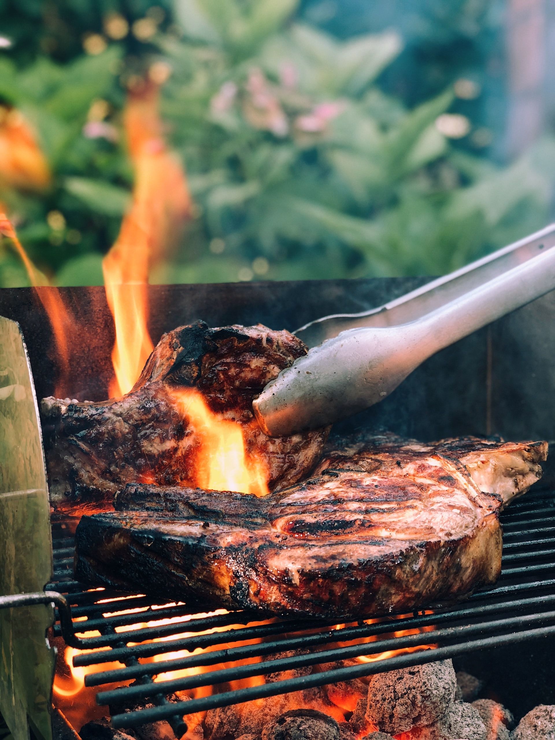 grilling-steaks-on-flat-top-grill smoked salmon on charcoal grill