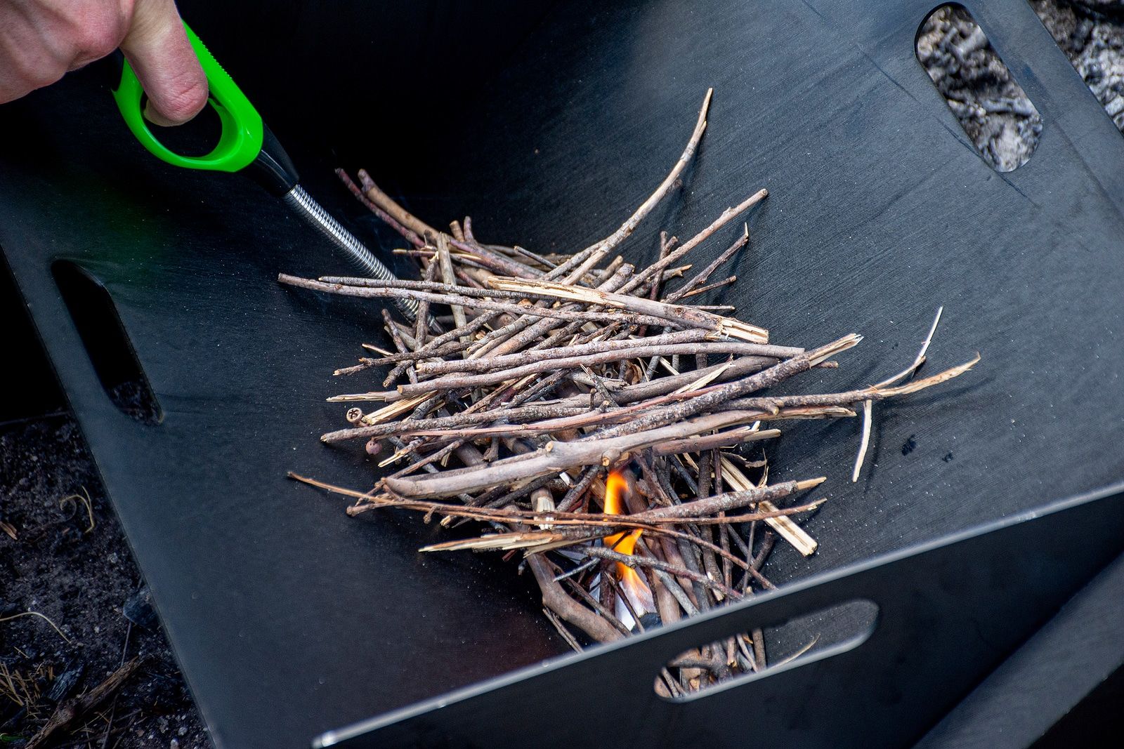 infrared-grill-heating-meat Starting The Camp Fire With Kindling And Lighter In A lighter